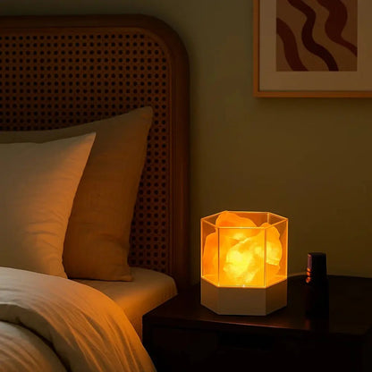 Salt lamp glowing warm on a bedside table at night